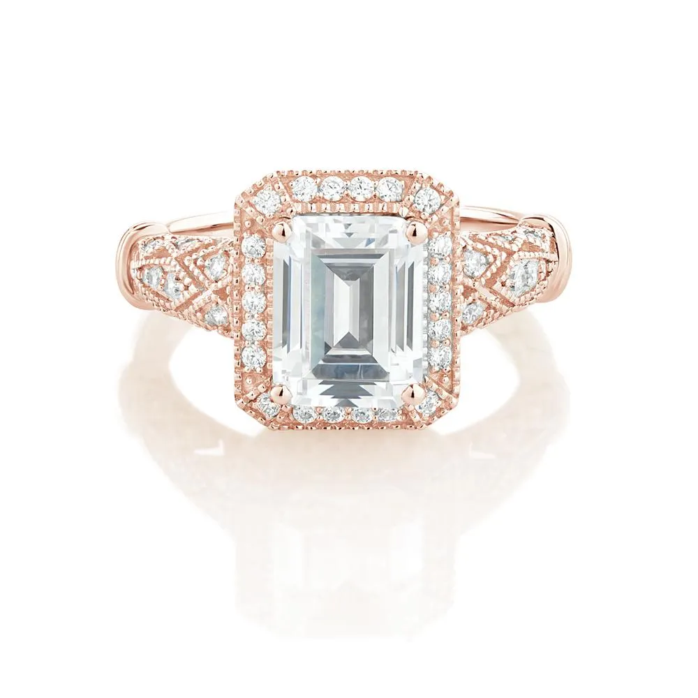 Emerald Cut and Round Brilliant halo engagement ring with 2.9 carats* of diamond simulants in 10 carat rose gold